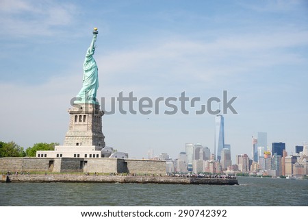 Liberty Statue with buildings in manhattan downtown new york as a background
