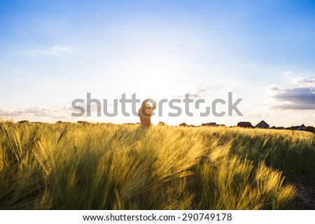 Teenage girl enjoy with sunshine in wheat field. Catch the sun