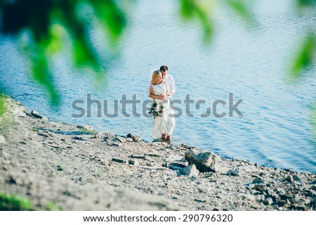 beautiful gorgeous blonde bride and stylish groom, on the background of a sea