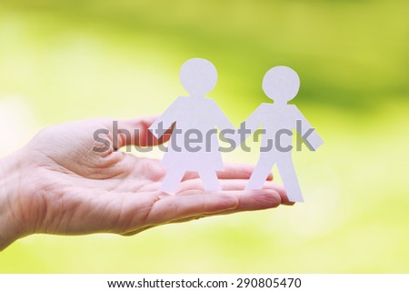 couple in hands - grass background 