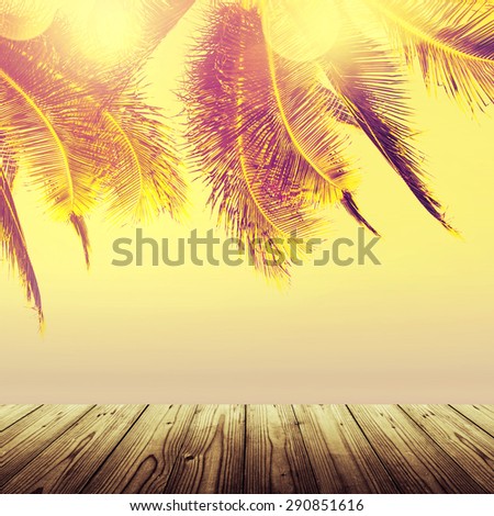 Empty wooden table. Coconut palm tree over the blurry ocean. Design banner background. Vintage effect.