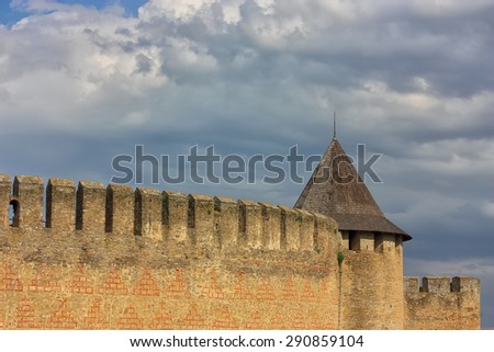 wall and tower ancient castle in  Khotyn. Blue sky with clouds.