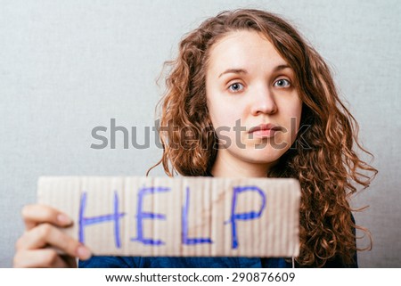 Pretty girl holding a sign help