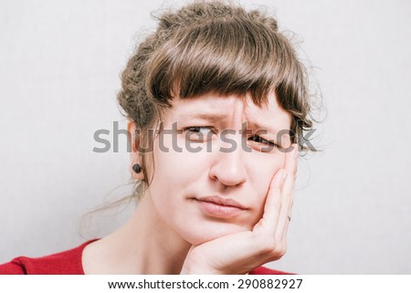 Woman hand of a person looking unhappy. On a gray background.