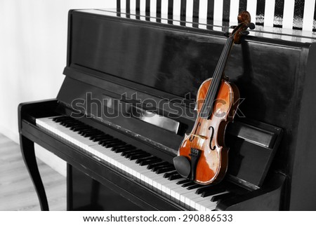 Violin on piano background