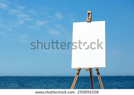 Easel with canvas on beach