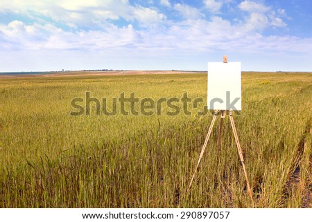 Easel with canvas in field