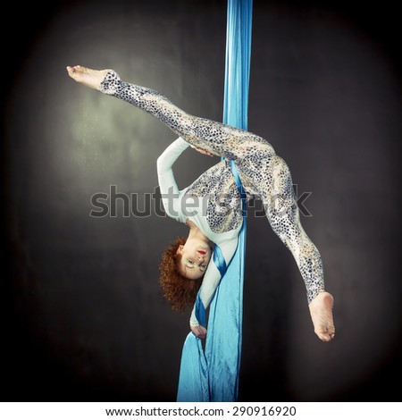 Girl`s workout on aerial ribbons