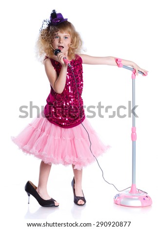 Young girl is singing with a microphone. Isolated on white background.