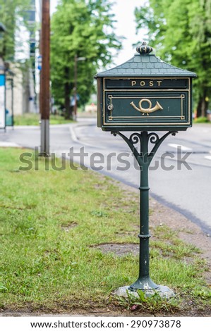 Green vintage mail box with urban background