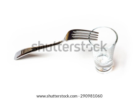 Photo of one glassy shot and fork on white background