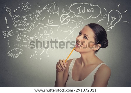 Portrait happy young woman thinking dreaming has many ideas looking up isolated grey wall background. Positive human face expression emotion feeling life perception. Decision making process concept. 