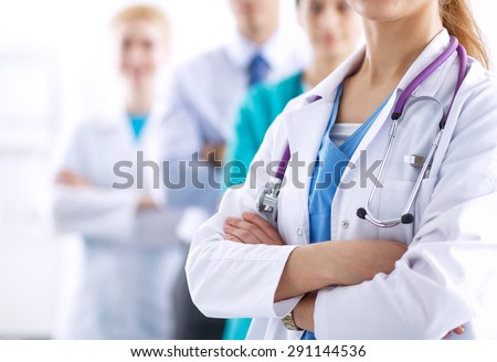Attractive female doctor in front of medical group . Royalty-Free Stock Photo #291144536