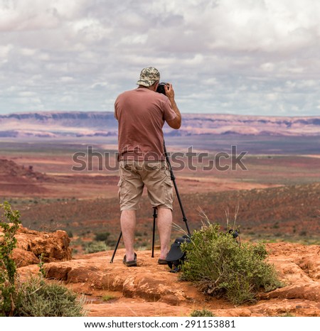 Hiker photographer taking picture of the Monument Valley from view point
