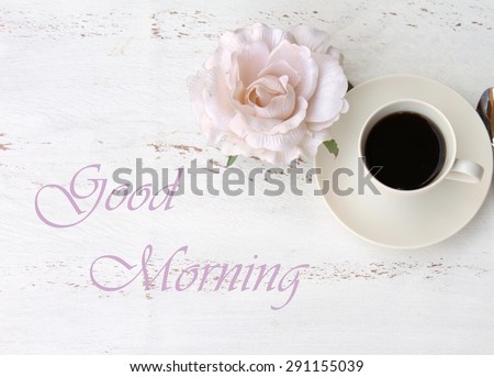 GOOD MORNING text, a cup of black coffee and a flower