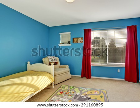Cute kids room with blue walls and carpet.