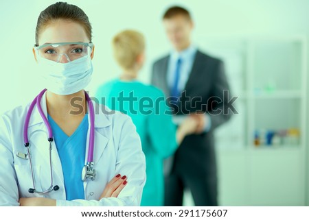 Woman doctor standing with stethoscope at hospital 