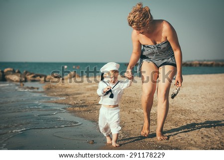 Happy family. Young happy beautiful mother and her son having fun on the beach. Positive human emotions, feelings, emotions.