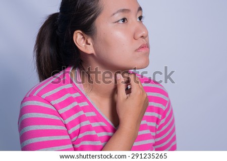 Portrait of young woman having a sore throat.