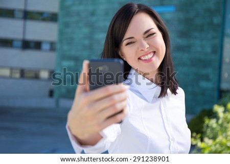 funny business woman making selfie photo on modern smartphone