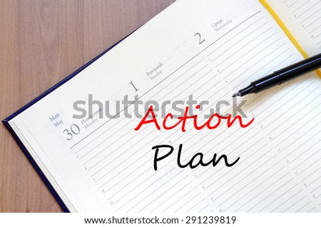 Yellow blank notepad on office wooden table and text concept