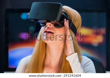 Girl with pleasure uses head-mounted display Royalty-Free Stock Photo #291241604