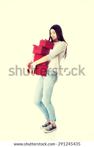 Pretty teen holding a lot of presents