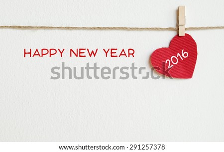 Red fabric heart with happy new year 2016 word hanging on the clothesline, new year template Royalty-Free Stock Photo #291257378