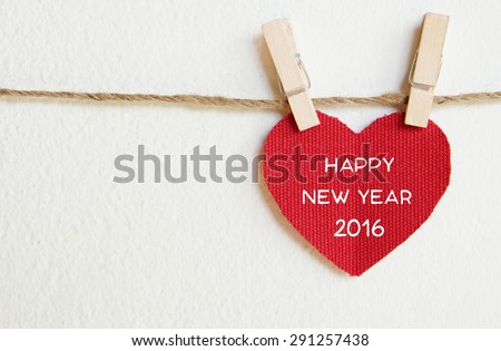 Red fabric heart with happy new year 2016 word hanging on the clothesline, new year template Royalty-Free Stock Photo #291257438