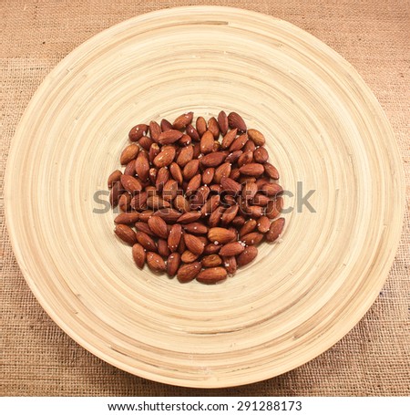 Salted Roasted Almonds Nuts on Wooden Surface/Roasted Almonds/Nuts