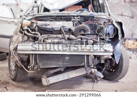 Crashed silver car with broken roof, front view. Royalty-Free Stock Photo #291299066