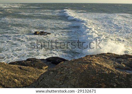 A sea with waves socking against the rocks