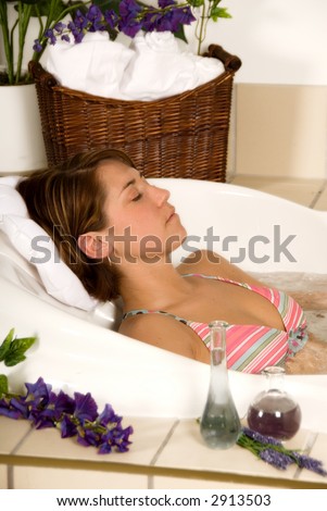brunette girl in a  spa bath relaxing