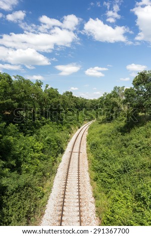 Railway in summer nature. Blue sky with white clouds