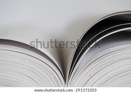 Open book with white blank pages on white background with narrow depth of field