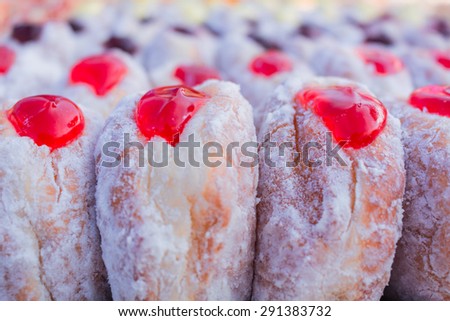 Fresh donuts with jam in the bakery.