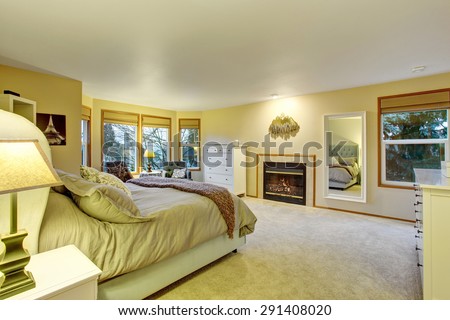Large master bedroom with fireplace and bed.
