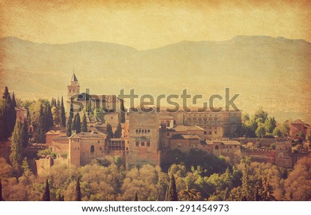 View of the Alhambra from the Albayzin of Granada,  Andalusia, Spain.
Photo in retro style.  Added  paper texture.