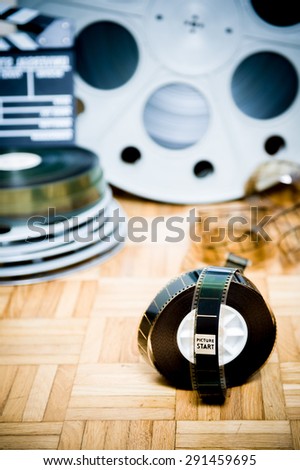 35 mm cinema movie filmstrip with picture start frame and other movie objects background vertical frame