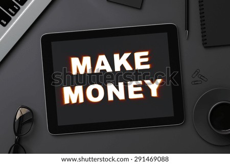 black digital tablet with make money and accessories