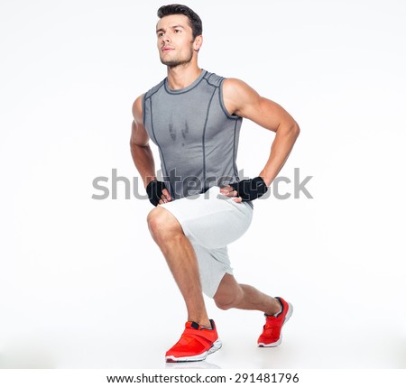 Full length portrait of a fitness man stretching isolated on a white background