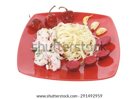 fresh rose wild salmon baked in cream cheese sauce with italian pasta and red hot pepper on square plate isolated over white background 