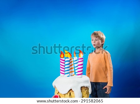 Boy blows out the candles on the cake