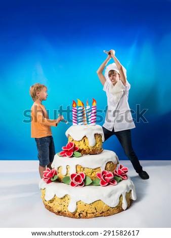 Cheerful confectioner and boy near a birthday cake