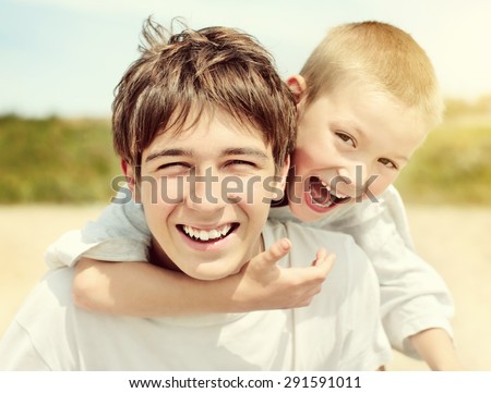 Toned Photo of Happy Teenager and Kid Portrait outdoor