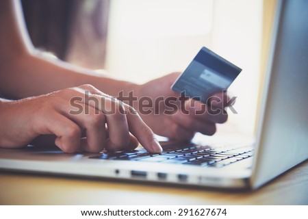 Hands holding credit card and using laptop. Online shopping Royalty-Free Stock Photo #291627674