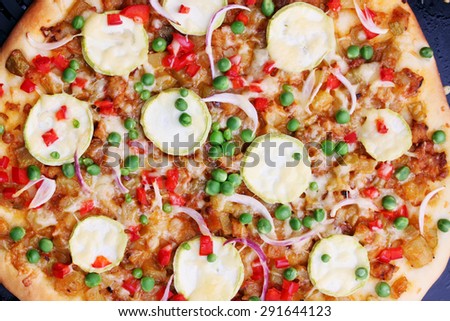 Vegetarian pizza with zucchini, green peas and peppers