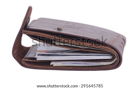 Genuine leather wallet isolated closeup shot. Picture shows side of the wallet, some notes and credit cards can be seen.
