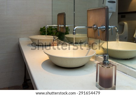 Chrome faucet with washbasin in modern bathroom