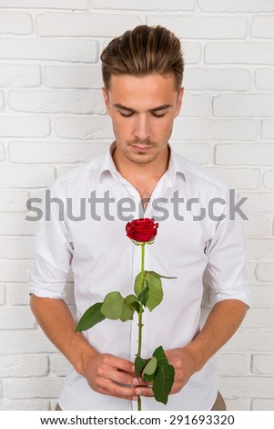 Romantic man holding a rose